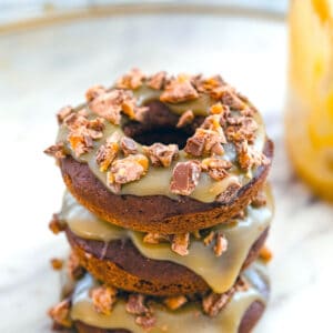 Milky Way Doughnuts -- These Milky Way Doughnuts are baked chocolate doughnuts topped with homemade caramel sauce and Milky Way pieces. They're easy to make and heavenly to eat! | wearenotmartha.com