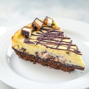 Milky Way Midnight Cheesecake -- This Milky Way Cheesecake is made with Milky Way Midnight Dark Chocolate bars for an extra decadent cheesecake that tastes like it came straight from a bakery | wearenotmartha.com