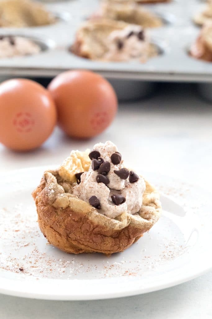 Mini Cinnamon Chocolate Chip German Pancakes with Cinnamon Whipped Cream -- bite-sized brunch made in a muffin tin! | wearenotmartha.com