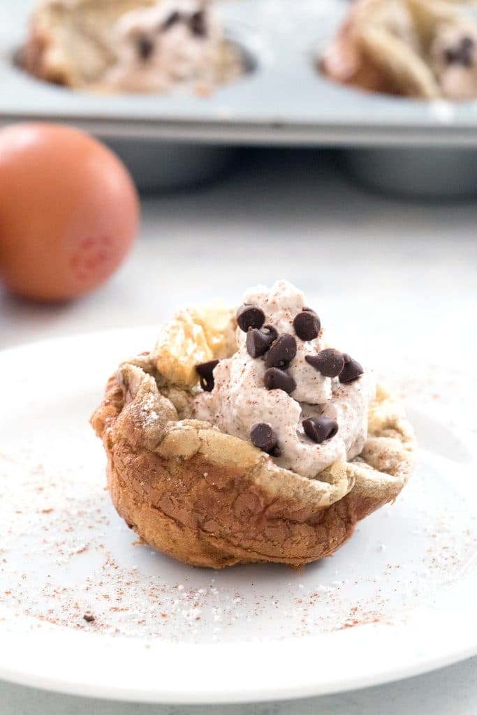 Mini Cinnamon Chocolate Chip German Pancakes with Cinnamon Whipped Cream -- bite-sized brunch made in a muffin tin! | wearenotmartha.com