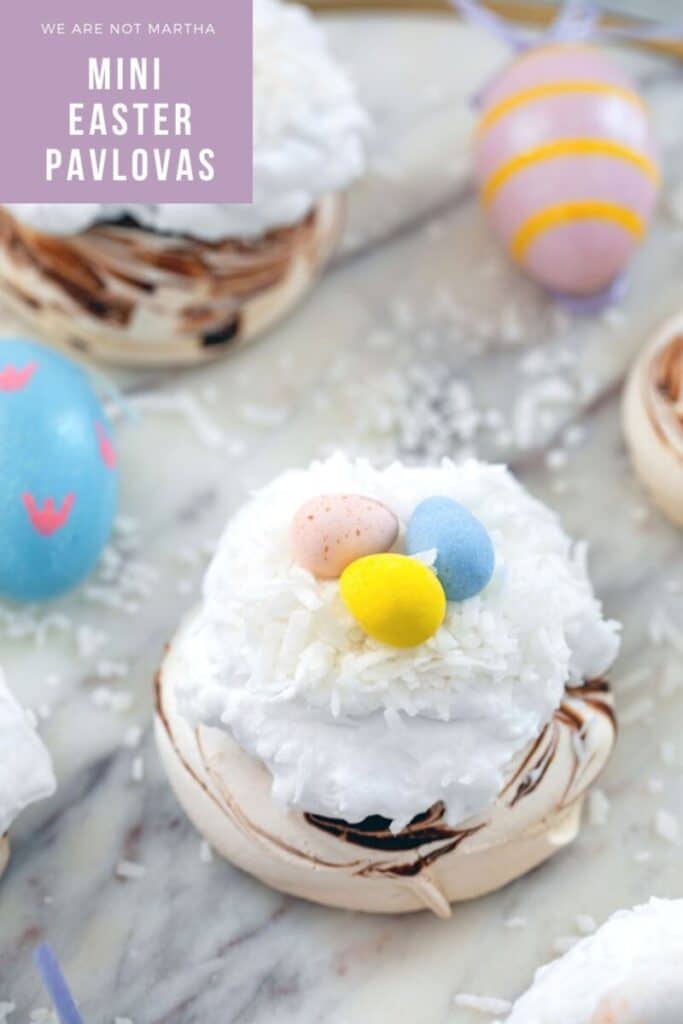 Mini Easter Pavlovas -- These Mini Easter Pavlovas have a chocolate swirled pavlova base and are topped with coconut whipped cream, shredded coconut, and Cadbury Mini Eggs. They make for a fun and delicious Easter dessert, but the mini pavlova base can be made any time of year | wearenotmartha.com #pavlovas #easter #coconut #cadburyeggs