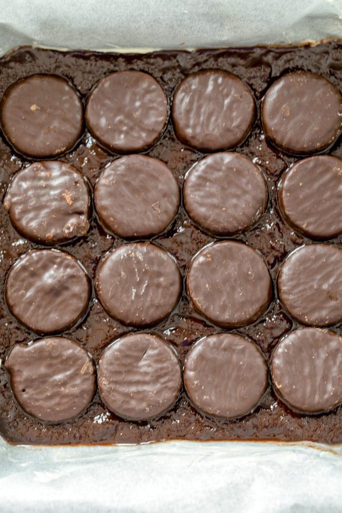 Baking pan with brownie batter and peppermint patties layered in it