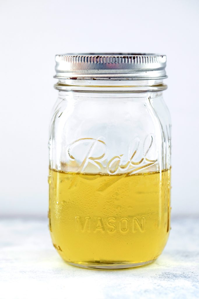 Head-on view of mint simple syrup in a mason jar