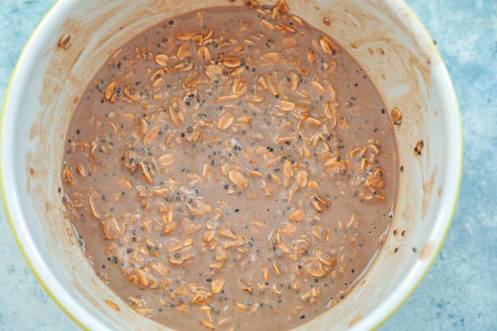 Overhead view of mocha overnight oats ingredients mixed together in a big bowl