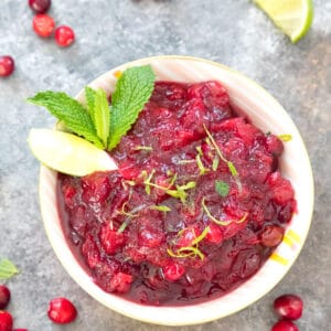 Mojito Cranberry Sauce -- Take your traditional holiday cranberry sauce and give it a cocktail twist! Rum, mint, and lime juice star in this Mojito Cranberry Sauce, perfect for your Thanksgiving or Christmas dinner | wearenotmartha.com