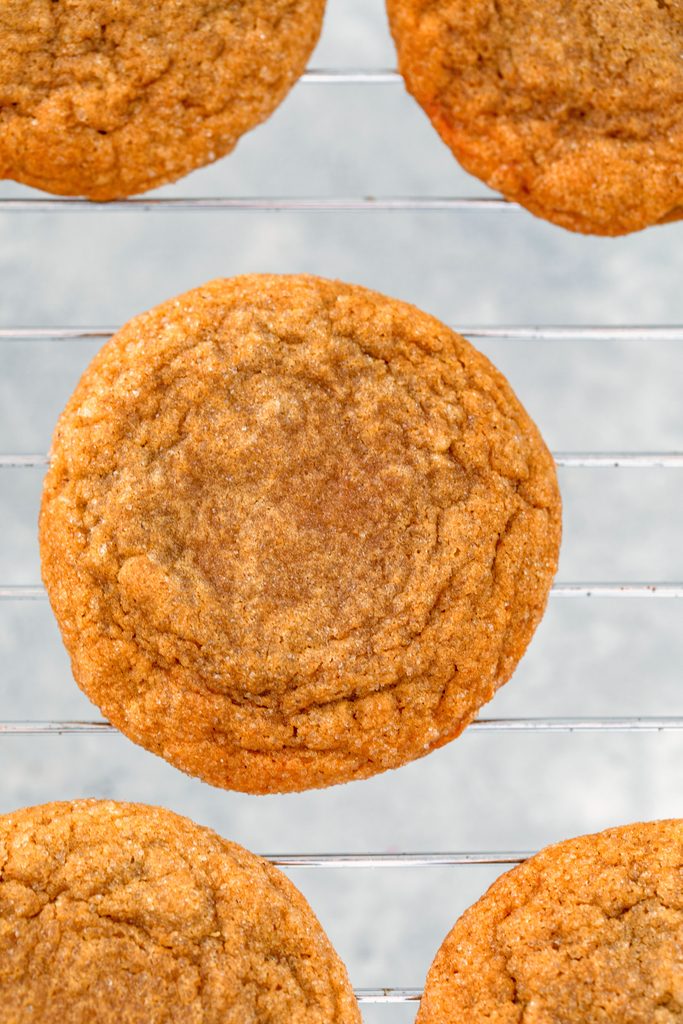 Overhead view of baked molasses ginger cookies on baking rack