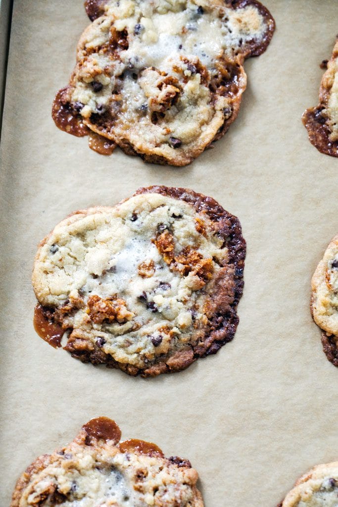 Momofuku Milk Bar Cornflake Chip Marshmallow Cookies baked with slightly burnt crispy edges on parchment paper-lined baking sheet