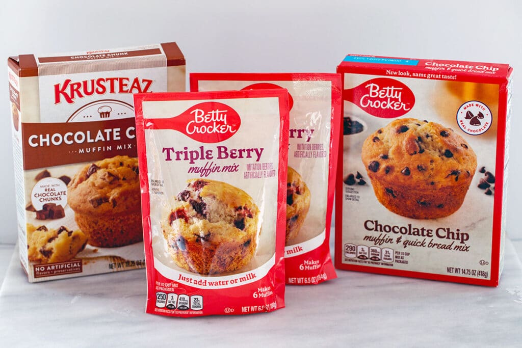 Three different size packages of muffin mix.
