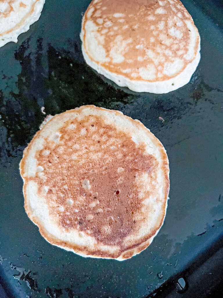 Pancakes cooking on griddle
