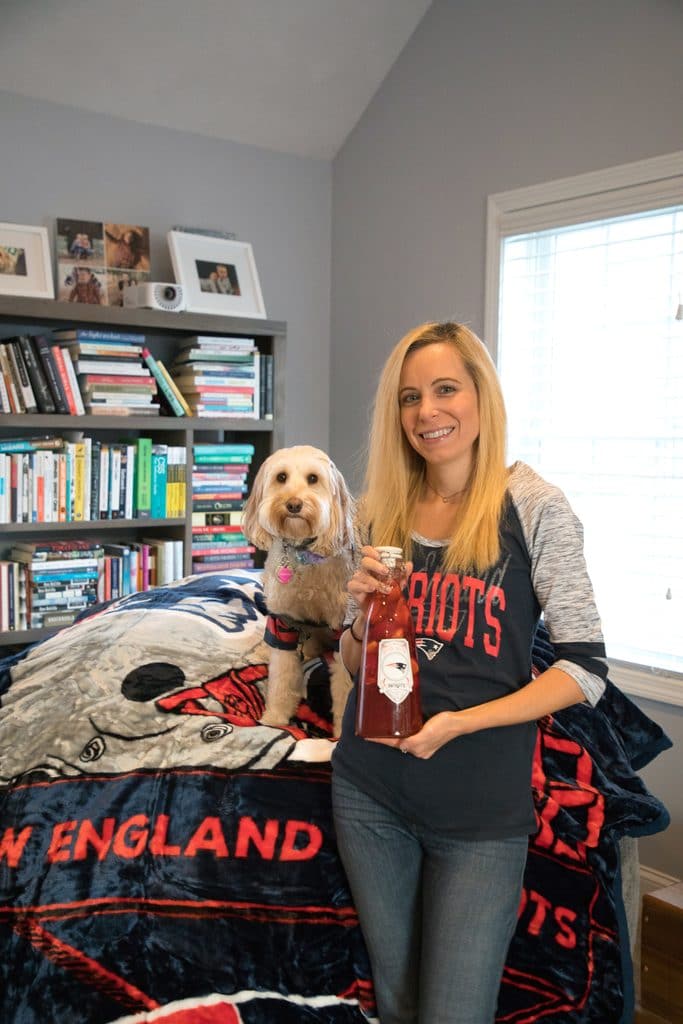 Sues and Winnie the Labradoodle showing off New England Patriots NFL Homegate gear