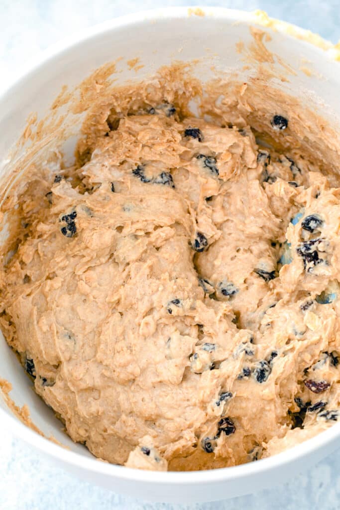 Overhead view of muffin batter with raisins.