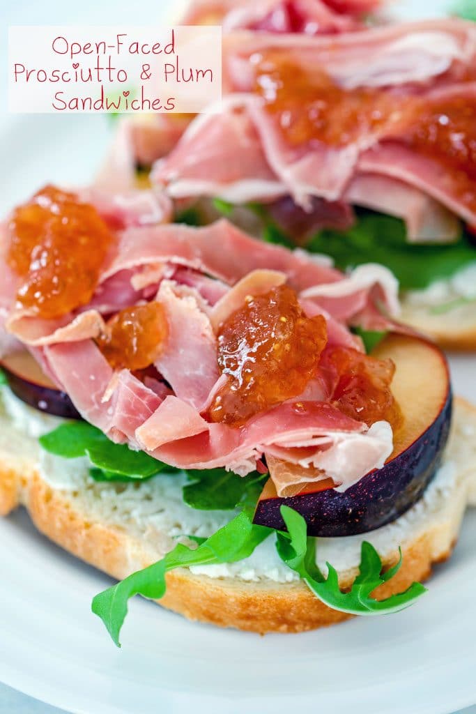 Up-close view of open-faced prosciutto and plum sandwiches with fig spread drizzled on top and "Open-Faced Prosciutto and Plum Sandwiches" text on top