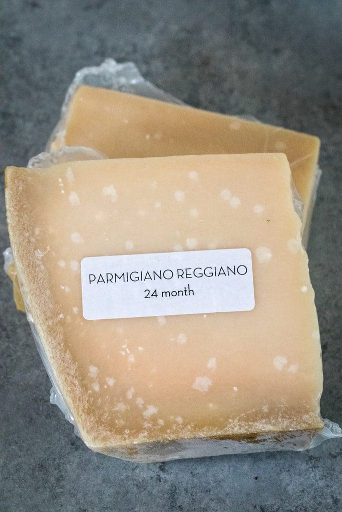 Overhead view of two blocks of parmigiano reggiano