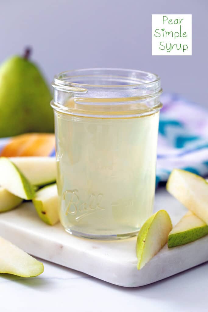 Head-on view of a small mason jar of pear simple syrup with sliced pears and a while pear in the background and recipe title at top.