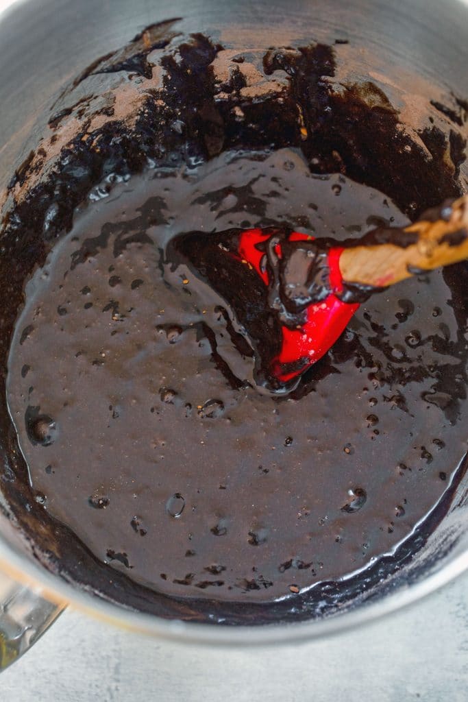 Overhead view of a mixing bowl filled with chocolate brownie batter