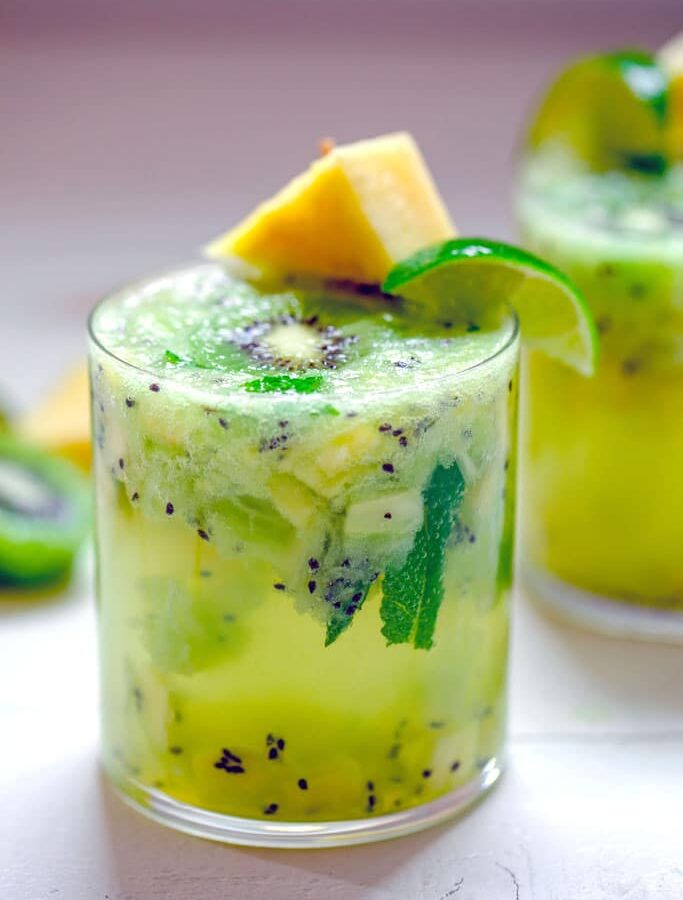 Pineapple Kiwi Mojito -- This Pineapple Kiwi Mojito is made with fresh fruit and no added sugars or other juices. It looks like a fancy cocktail, but you'll be surprised by how simple it is to prepare and enjoy on a hot summer day | wearenotmartha.com
