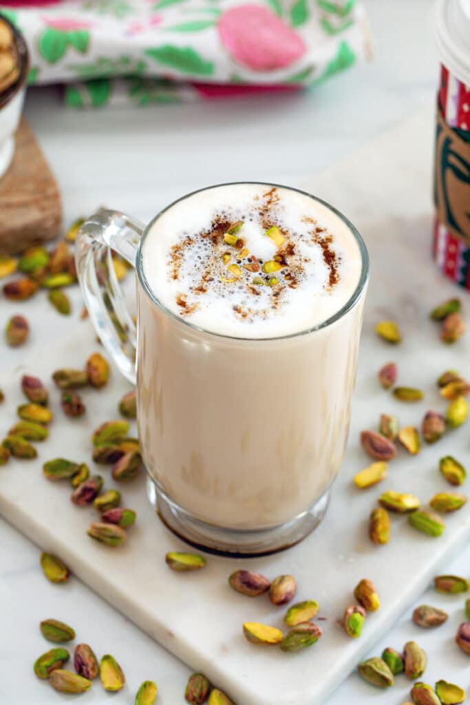 Overhead view of a grande pistachio latte Starbucks copycat with shelled pistachios all around