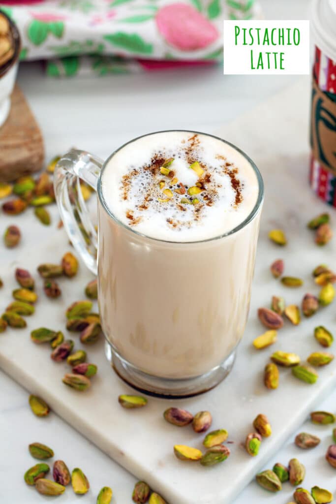 Overhead view of a grande pistachio latte Starbucks copycat with shelled pistachios all around and recipe title at top