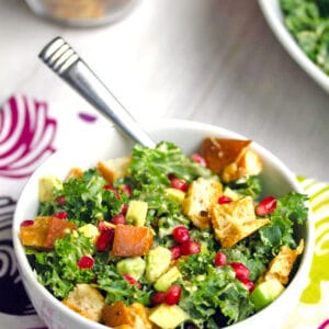 Pomegranate Avocado Kale Caesar Salad -- Caesar salads are nice, but they're even better when made with kale and avocado. This Pomegranate Avocado Kale Caesar Salad with parmesan croutons is the most delicious side or entree salad! | wearenotmartha.com