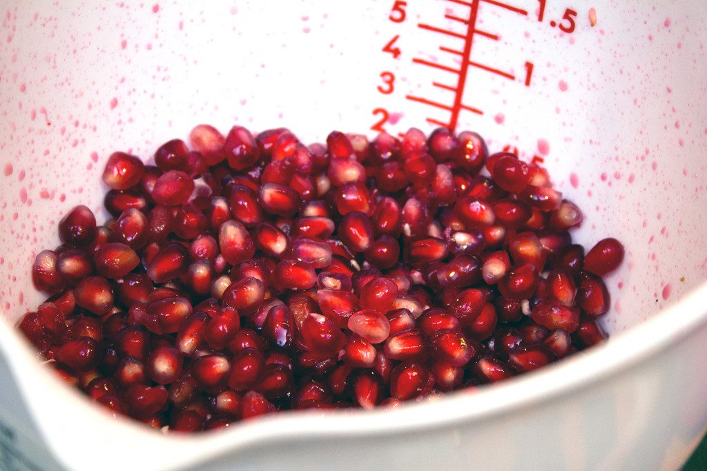 Mixing bowl filled with pomegranate arils