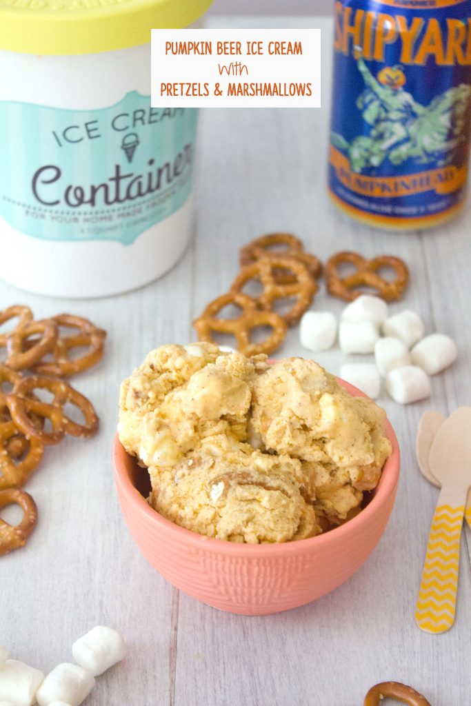 Head-on view of a bowl of pumpkin beer ice cream with pretzels, mini marshmallows, wooden spoons, can of pumpkin beer, and quart of ice cream in the background and recipe title at top