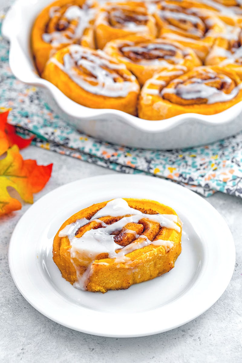 Pumpkin Cinnamon Rolls -- When there's a chill in the air, all I want to do is cuddle up on the couch with a cinnamon roll and a cup of coffee. These Pumpkin Cinnamon Rolls are packed with pumpkin spice flavor and drizzled with a deliciously sweet icing, making for the perfect fall breakfast or afternoon treat | wearenotmartha.com