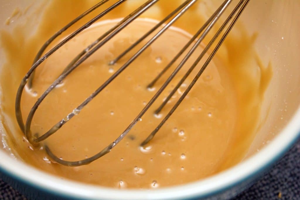 Maple frosting being whisked in a bowl