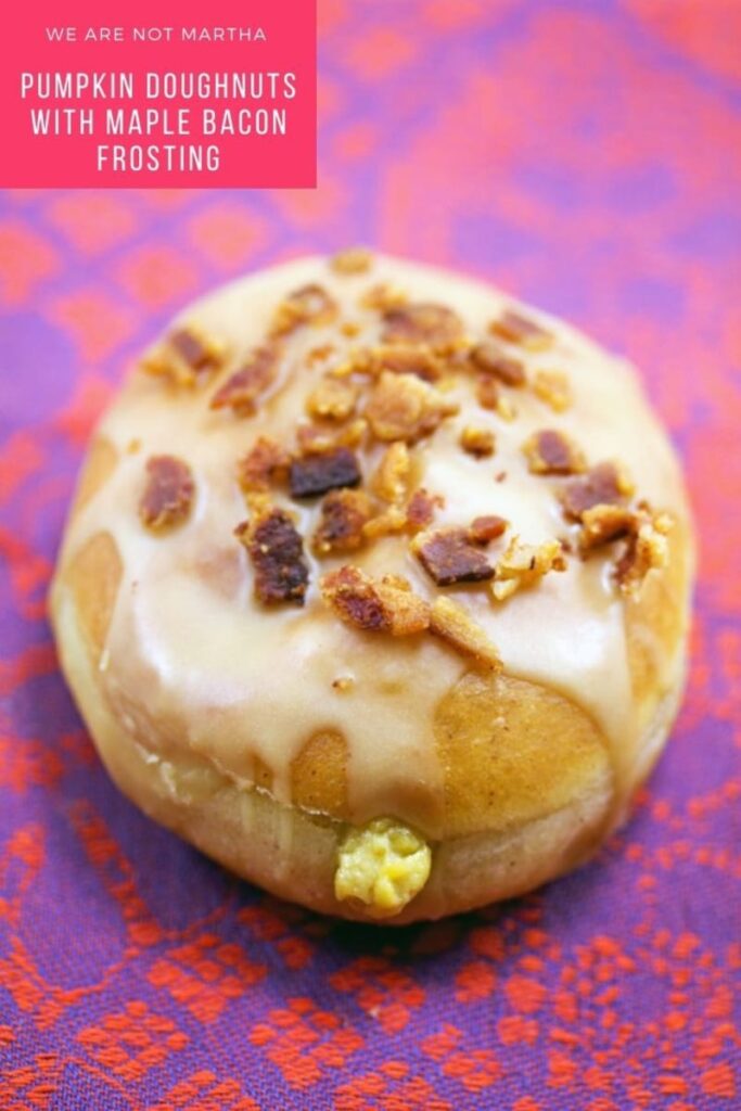 These Pumpkin Doughnuts are filled with a pumpkin custard and topped with a maple bacon frosting... Fall in donut form! | wearenotmartha.com #pumpkindonuts #falldonuts #pumpkindesserts #falldoughnuts