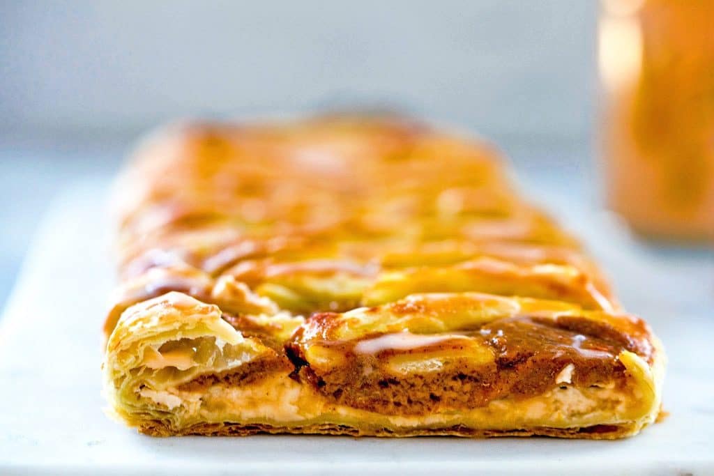 Head-on close-up of the pumpkin pastry cream and cream cheese filling in the pumpkin eggnog danish