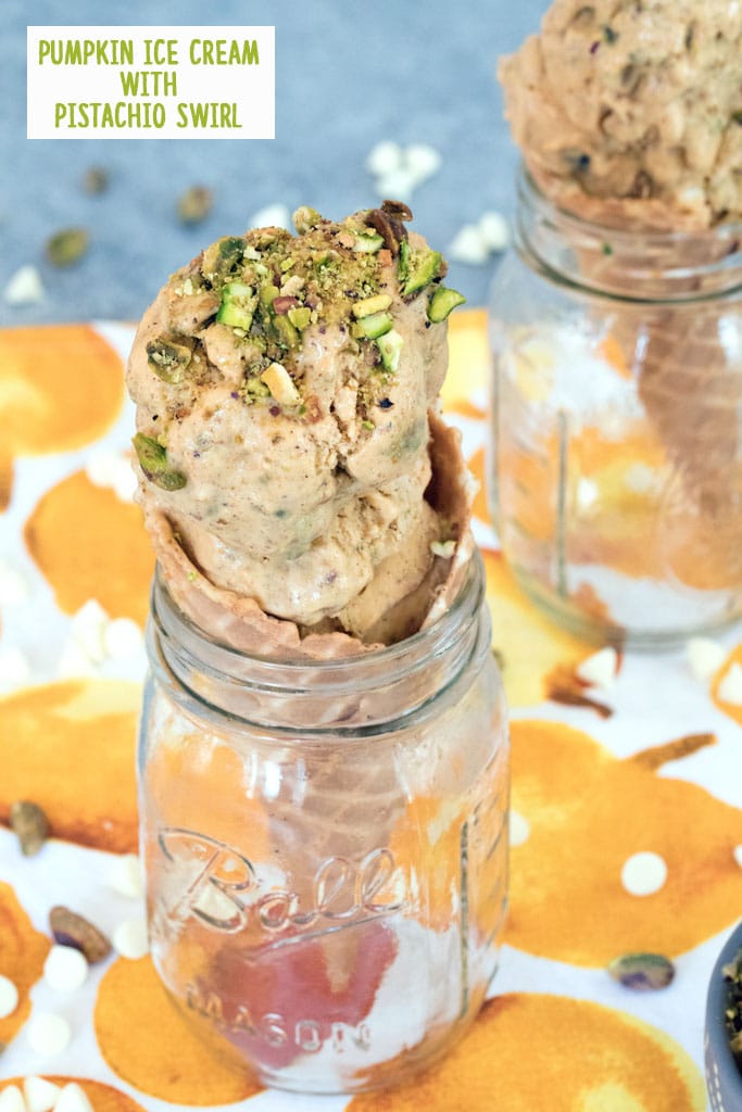 Head-on view of pumpkin ice cream with pistachio swirl in a cone set in a mason jar with a second cone in the background with recipe title at top