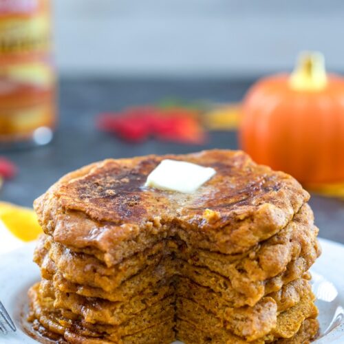 Pumpkin Pancakes -- Made with part whole wheat flour, these Pumpkin Pancakes will blow your mind with how moist and flavorful they are. Your crisp fall mornings are about to get a whole lot cozier with pumpkin pancakes on the menu | wearenotmartha.com