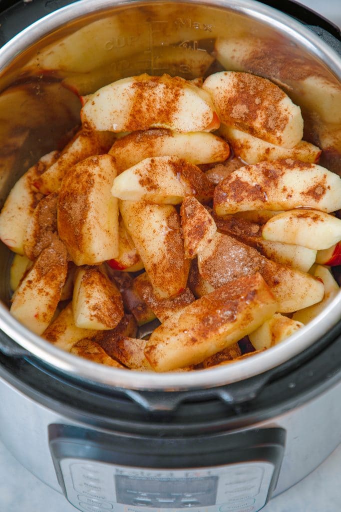 Overhead view of Instant Pot bowl filled with sliced apples and spices