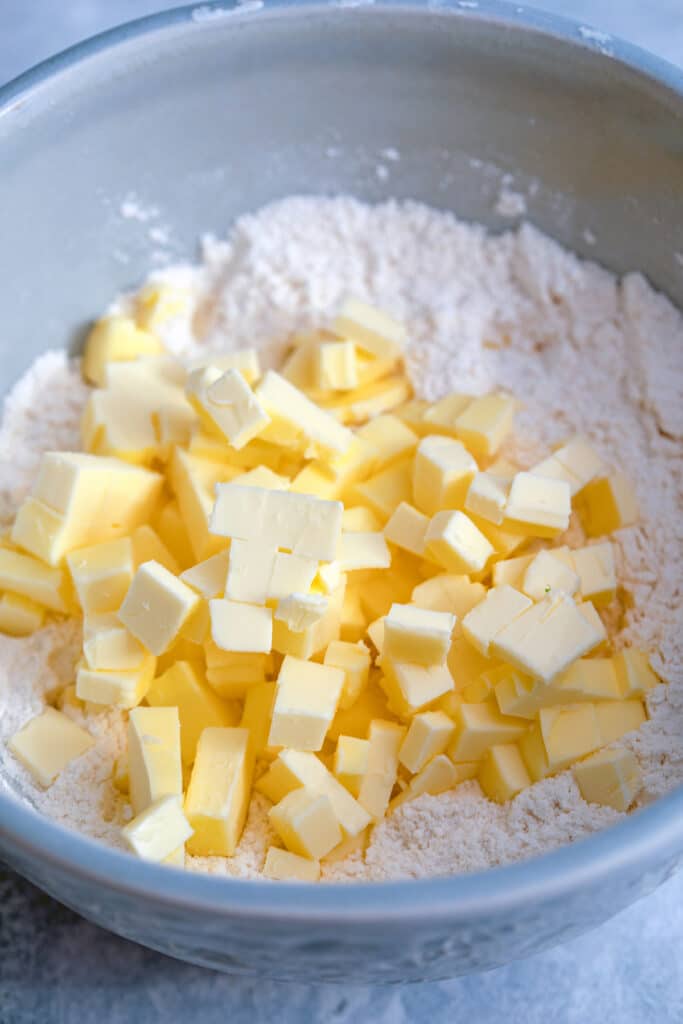 Cubes of butter in bowl with flour mixture