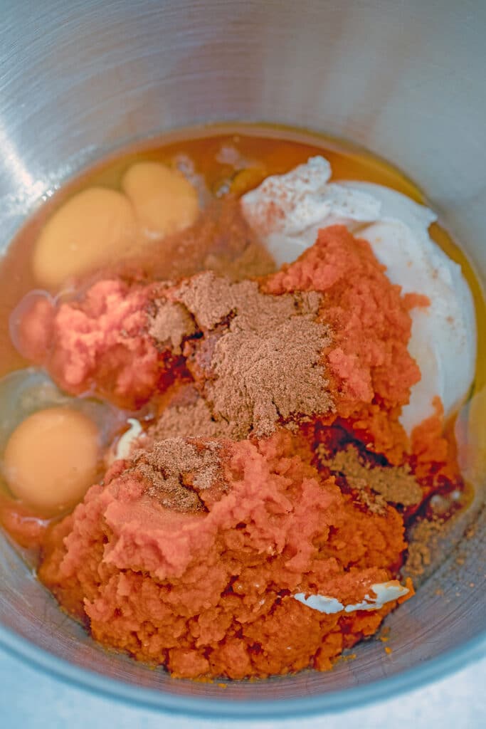 Mixing bowl with pumpkin puree, eggs, sugar, and spices