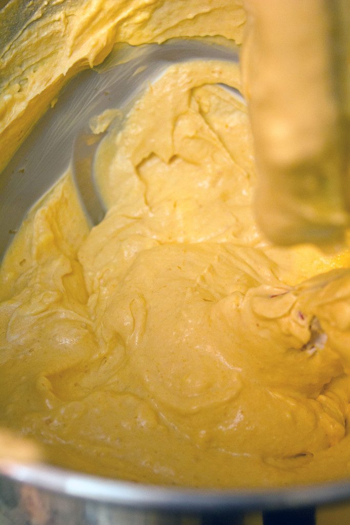 Overhead view of pumpkin spice cheesecake batter in a mixing bowl