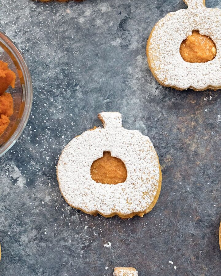 Pumpkin Spice Linzer Cookies -- These Pumpkin Spice Linzer Cookies are filled with pumpkin cinnamon buttercream and are the perfect pumpkin-shaped fall cookie | wearenotmartha.com
