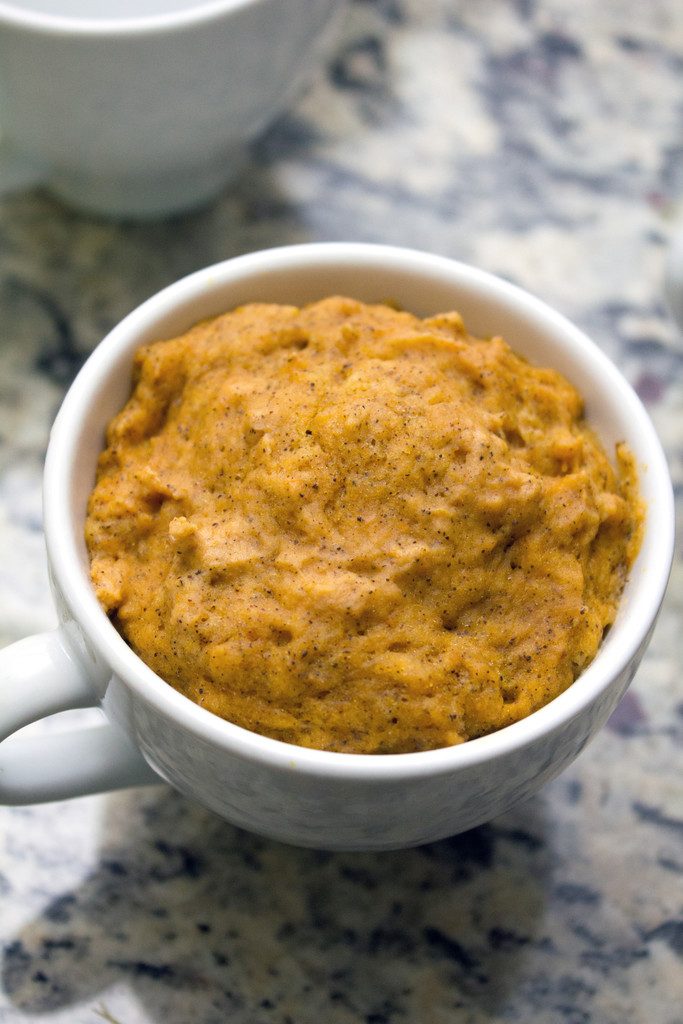 Overhead view of pumpkin mug cake baked in white mug