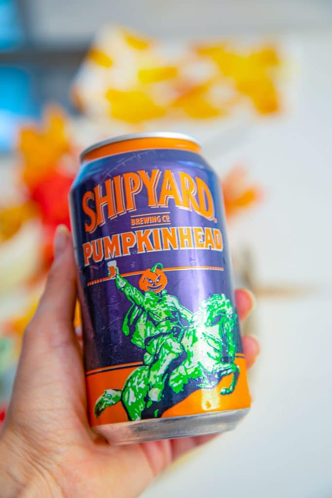 Hand holding can of Shipyard Pumpkinhead beer