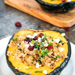 Quinoa-Stuffed Acorn Squash -- Quinoa-Stuffed Acorn Squash is the perfect healthy dinner for the holiday season and beyond. The tender acorn squash stuffed with a delicious quinoa and mushroom filling and topped with feta is incredibly filling and satisfying | wearenotmartha.com