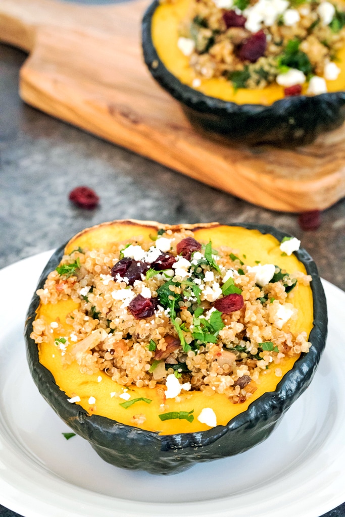 Quinoa-Stuffed Acorn Squash -- Quinoa-Stuffed Acorn Squash is the perfect healthy dinner for the holiday season and beyond. The tender acorn squash stuffed with a delicious quinoa and mushroom filling and topped with feta is incredibly filling and satisfying | wearenotmartha.com