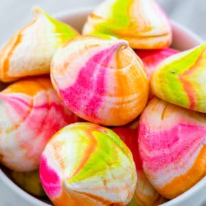 Rainbow Sherbet Meringues -- These Rainbow Sherbet Meringues are packed with orange, lime, and raspberry flavors and taste just like a bowl of rainbow sherbet... Except they won't melt! | wearenotmartha.com