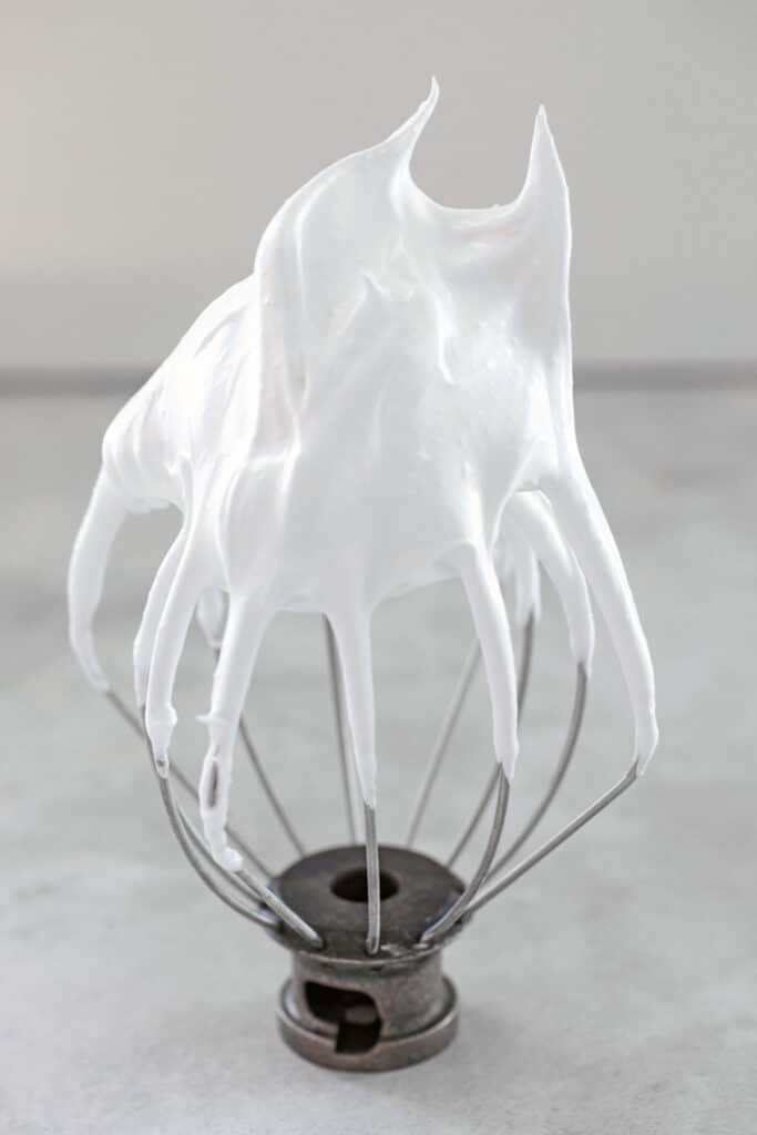 Head-on view of a wire whisk beater from a mixer with stiff egg whites