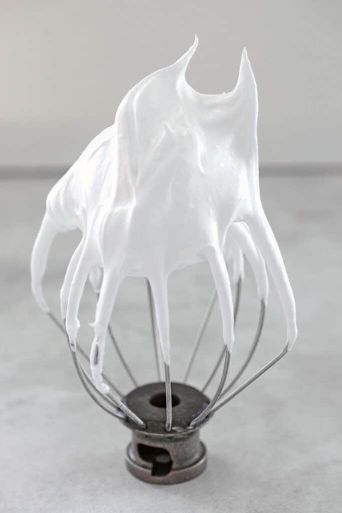 Head-on view of a wire whisk beater from a mixer with stiff egg whites.