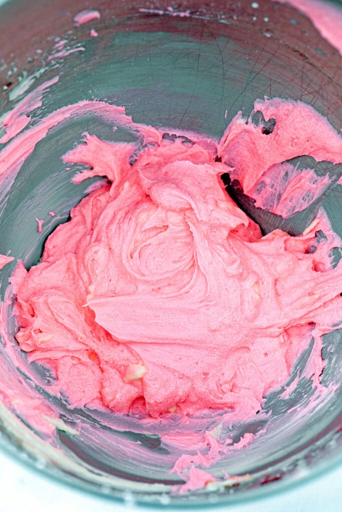 Raspberry buttercream frosting in mixing bowl