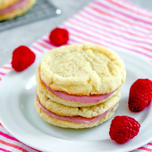 Raspberry Cream Sandwich Cookies -- These Raspberry Sandwich Cookies are made up of delicate vanilla sugar cookies and a delightful fresh raspberry and white chocolate filling | wearenotmartha.com