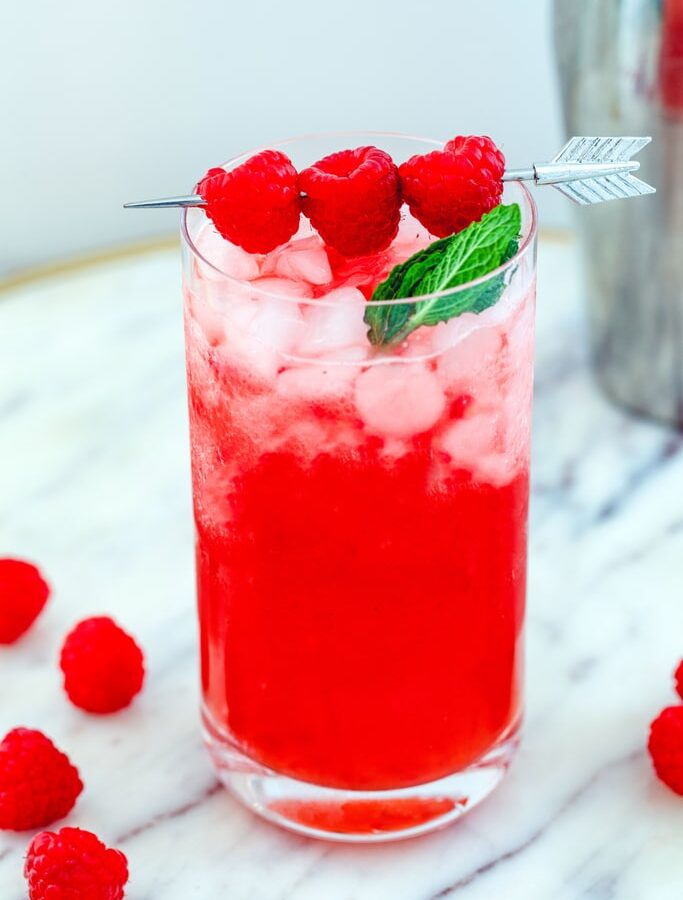 Head-on view of a raspberry vanilla whiskey cocktail with raspberry garnish.