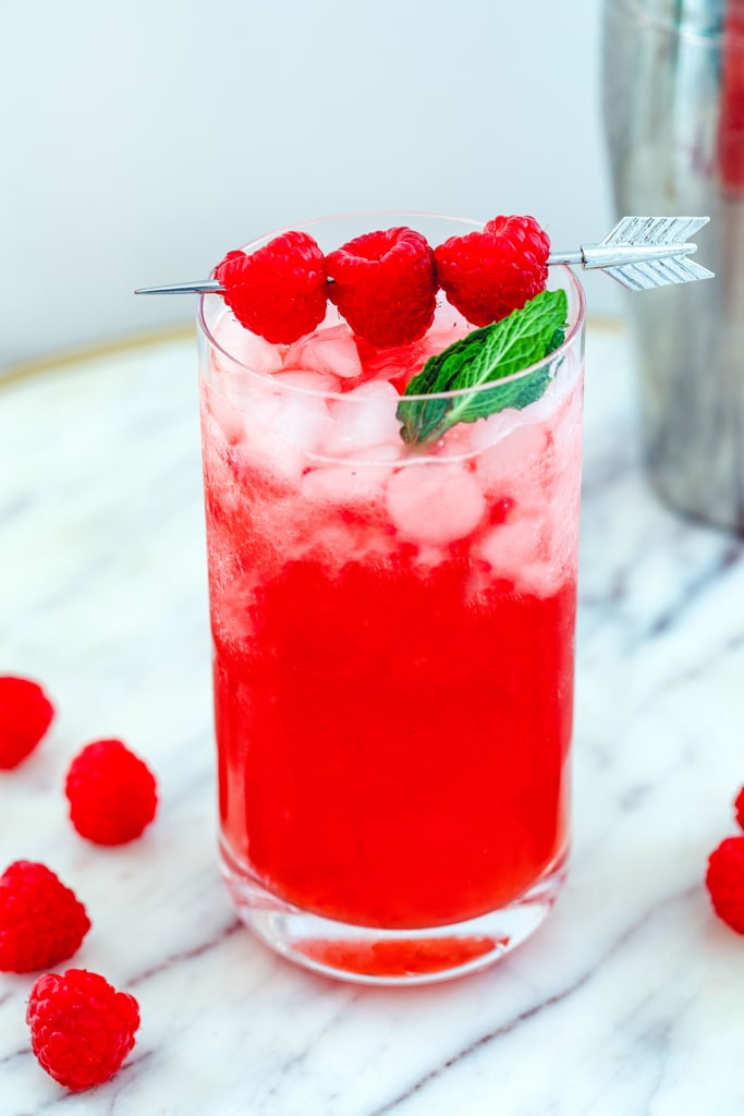 Head-on view of a raspberry vanilla whiskey cocktail with raspberry garnish.