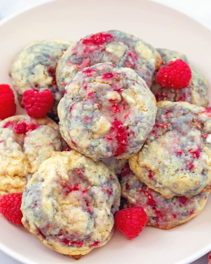 Close-up view of raspberry white chocolate cookies on a plate.