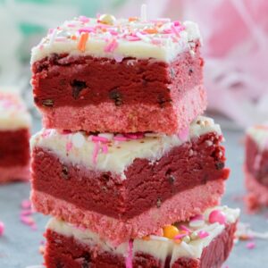 Red Velvet Cookie Dough Bars -- Perfect for showing your love this Valentine's Day, these treats are composed of a pink cookie crust, a luscious layer of chocolate chip red velvet cookie dough, and a white chocolate ganache topping | wearenotmartha.com
