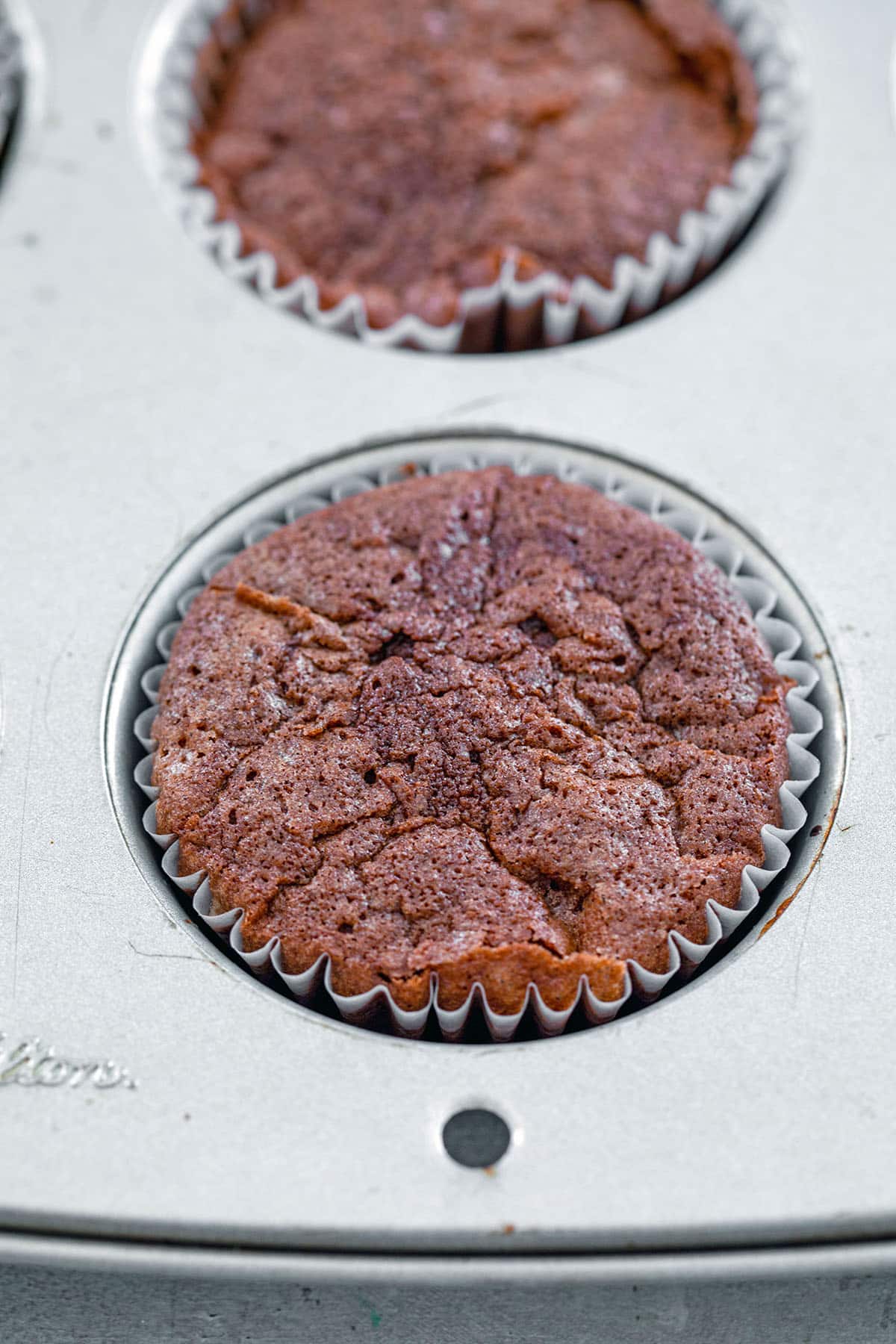 Chocolate red wine cupcakes just out of oven in tin.